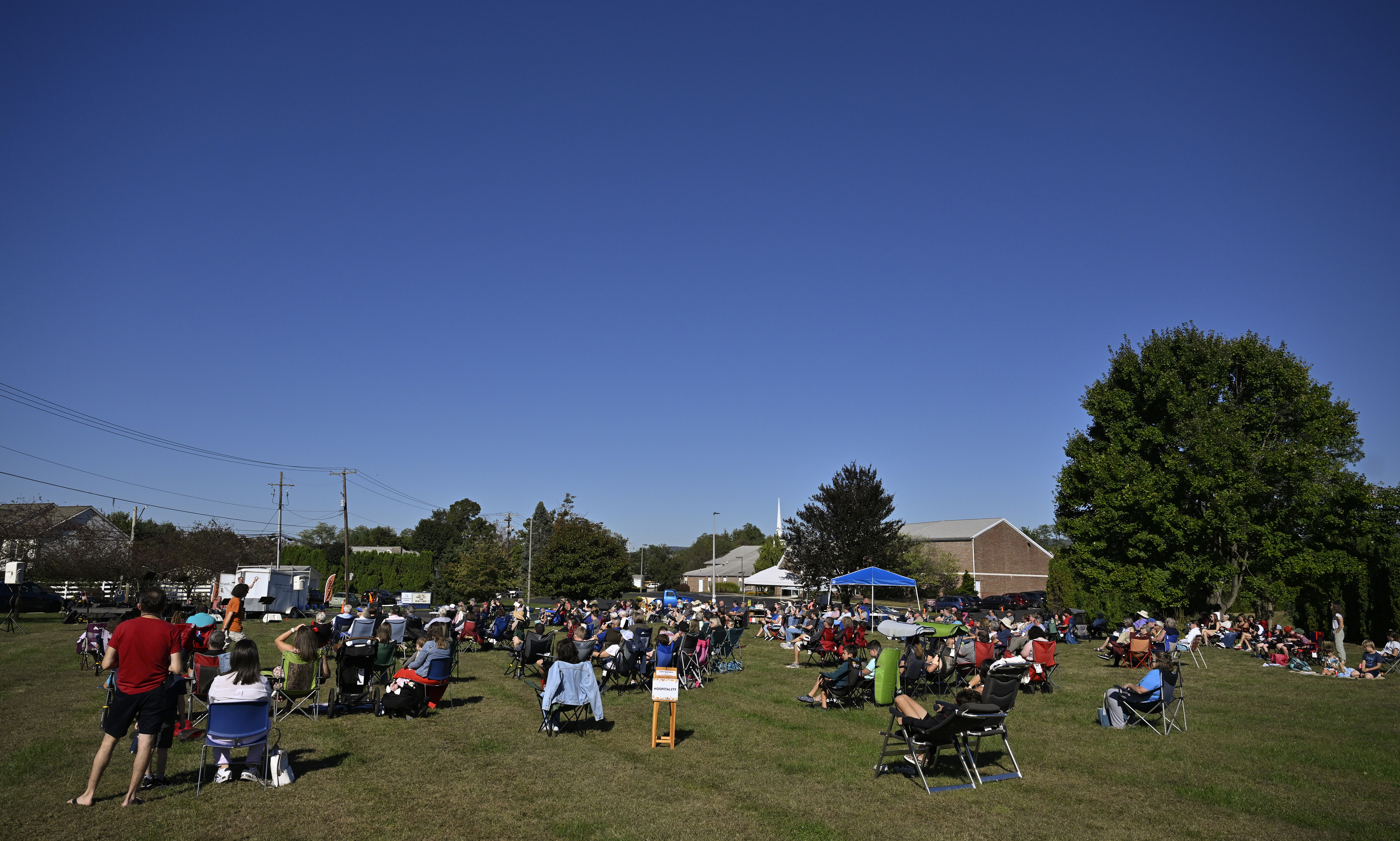 Community gathering on the green outside the church