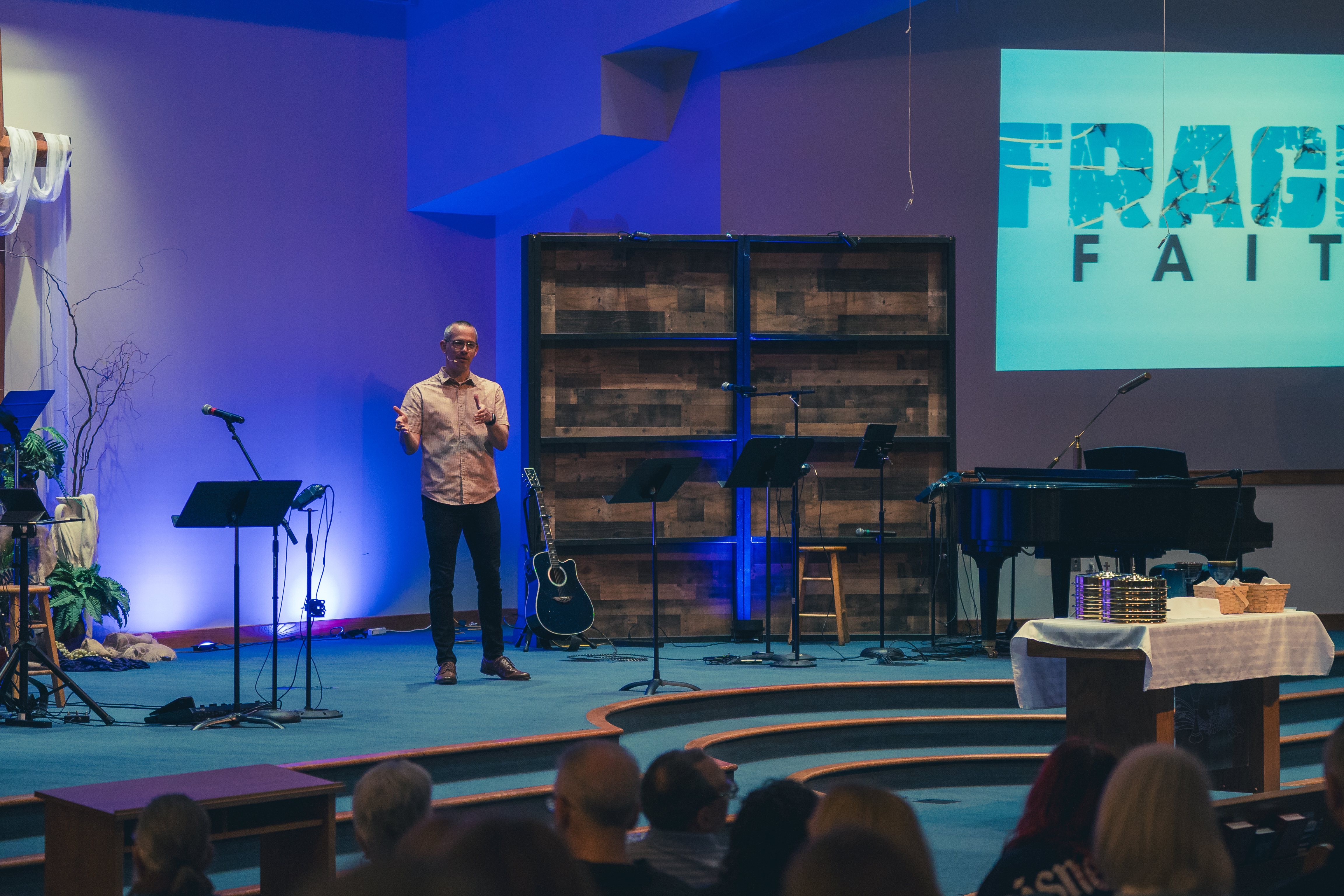 Pastor David preaching on the sanctuary stage