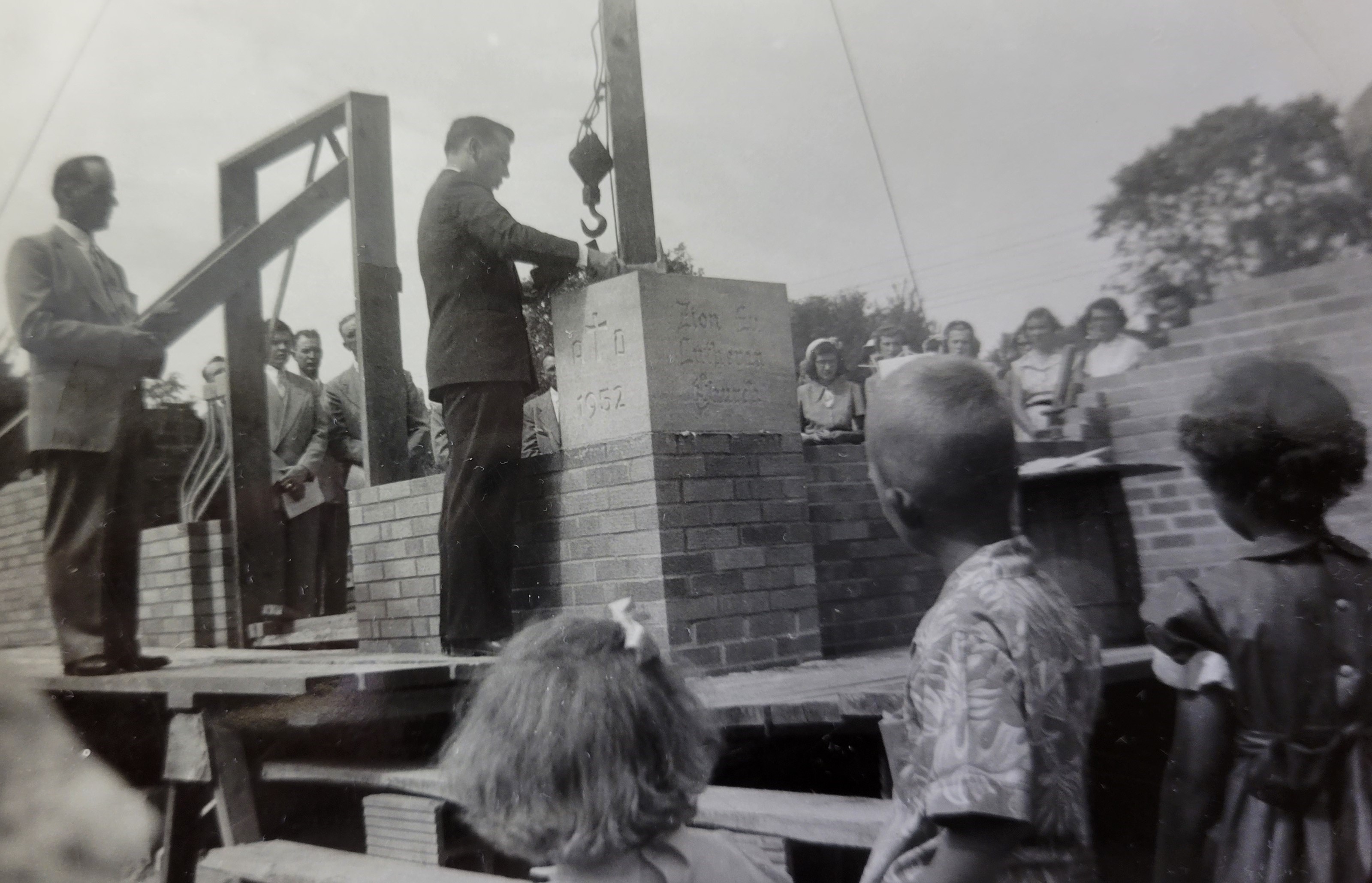Pastor laying the cornerstone on the church