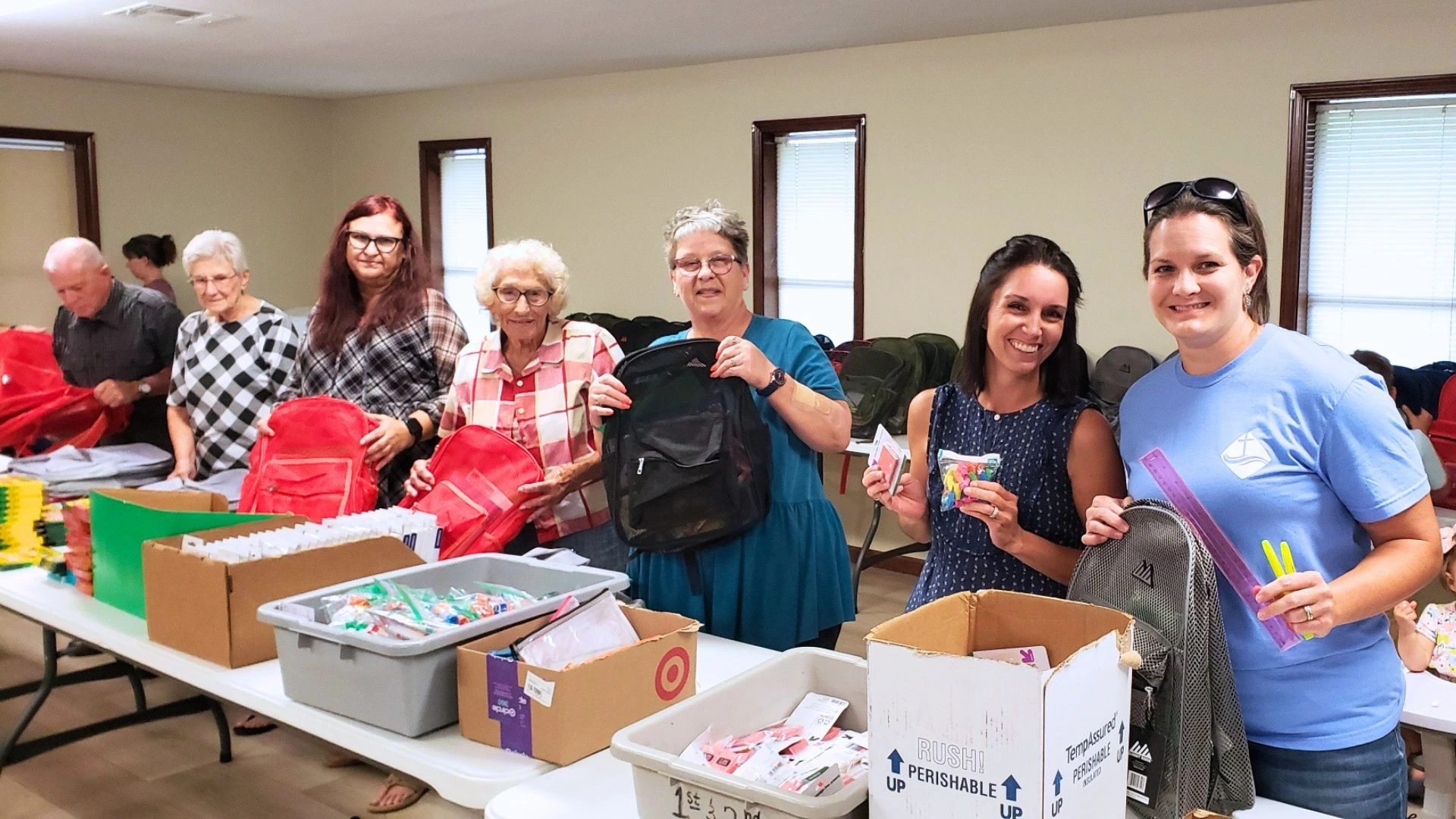 Volunteers packing backpacks for a community outreach project at Faith Bible Church