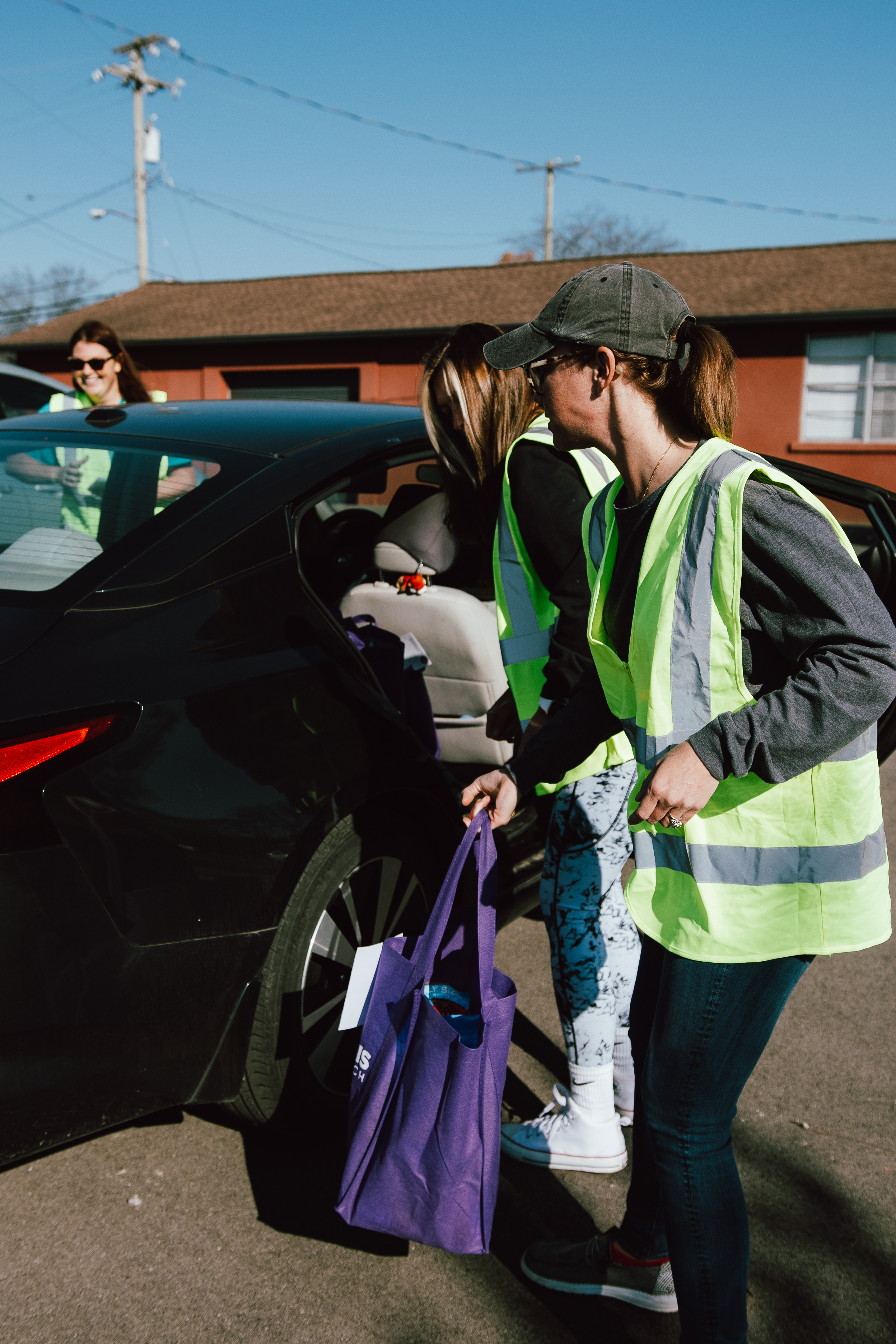 Volunteers bringing a Thanksgiving meal bag to a family’s car at Give a Meal in Hendersonville.