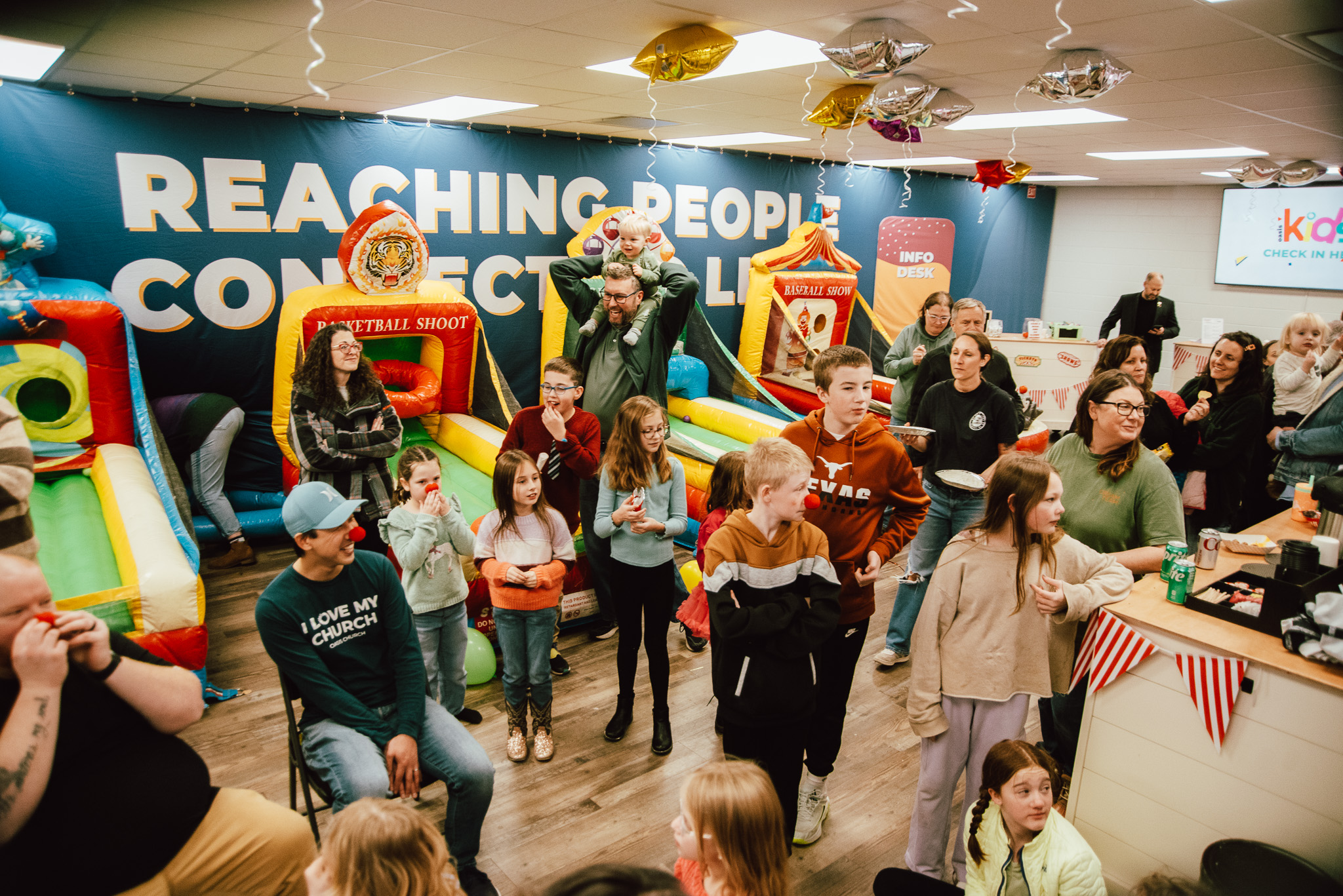Families and children enjoying carnival games at an Oasis Church event in Hendersonville, Tennessee.