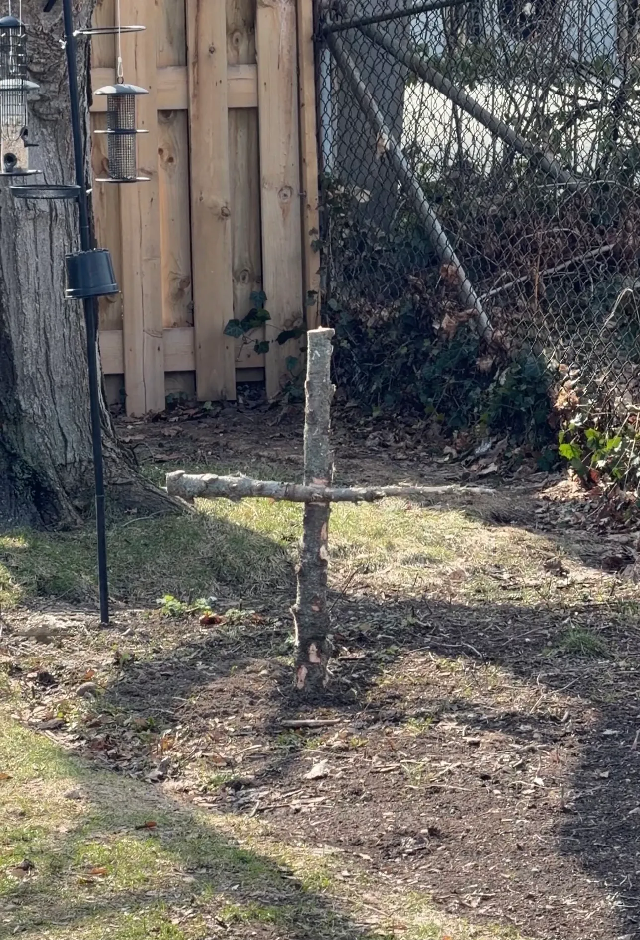 Wooden cross in a barren garden