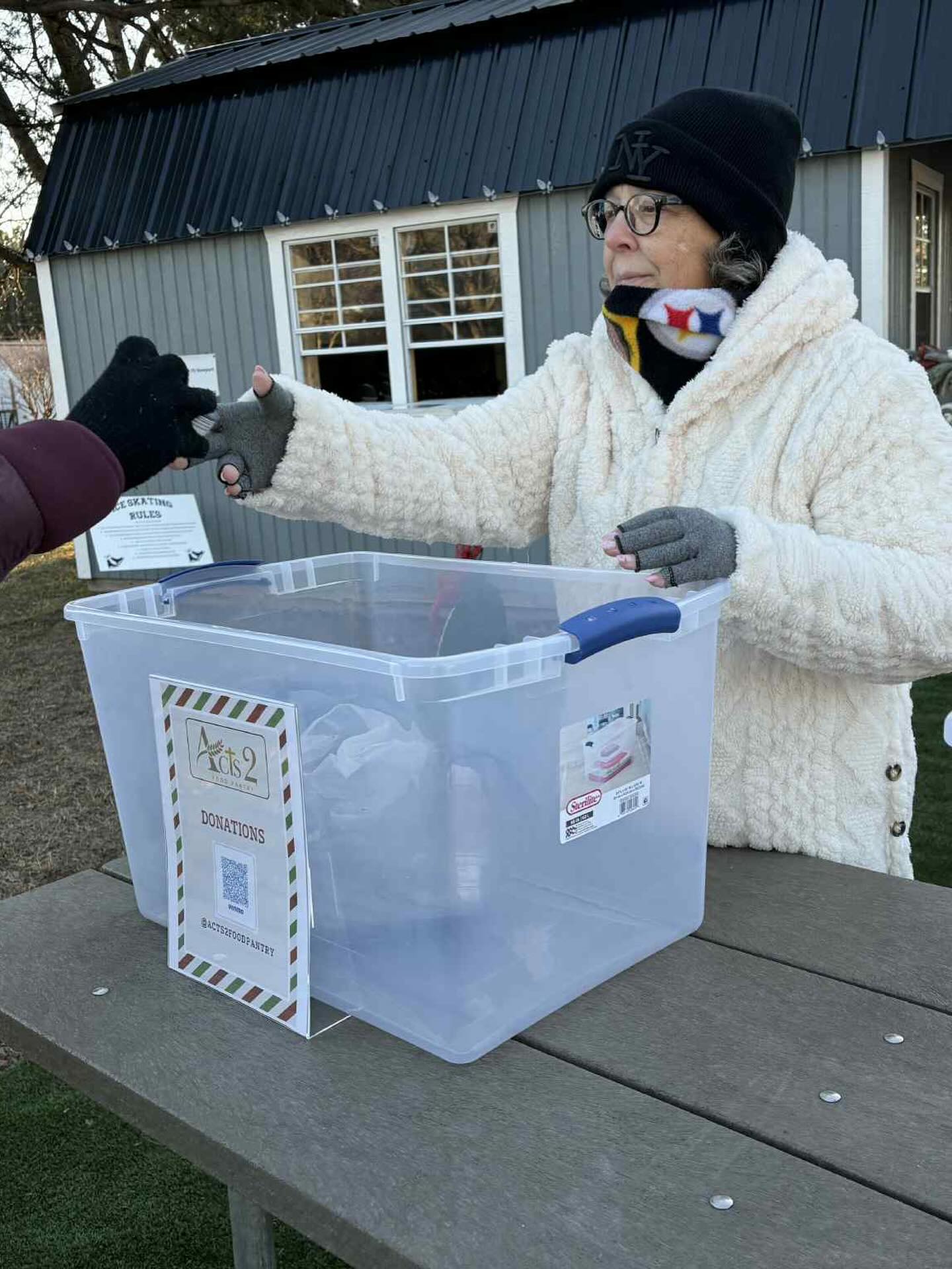 Volunteer collecting food donations for Acts2 Food Pantry serving families in Newport, NC
