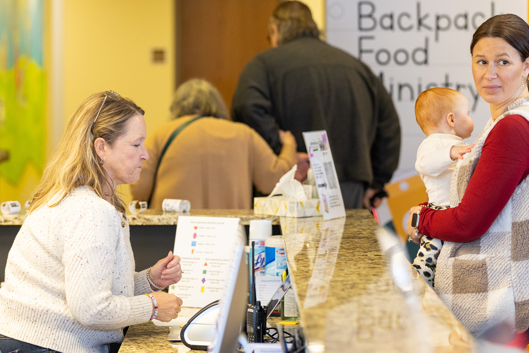 Volunteers serving at a church welcome table