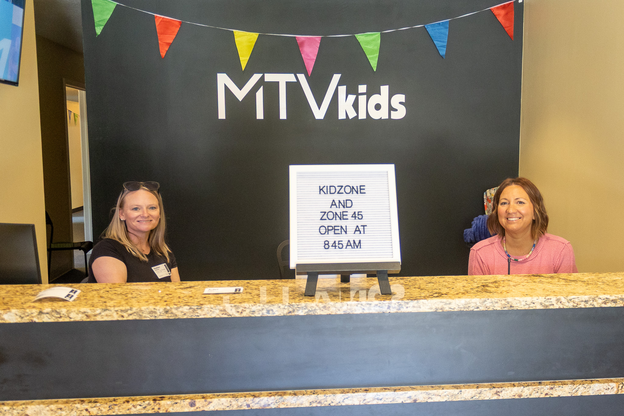 Volunteers staffing the kids check-in desk