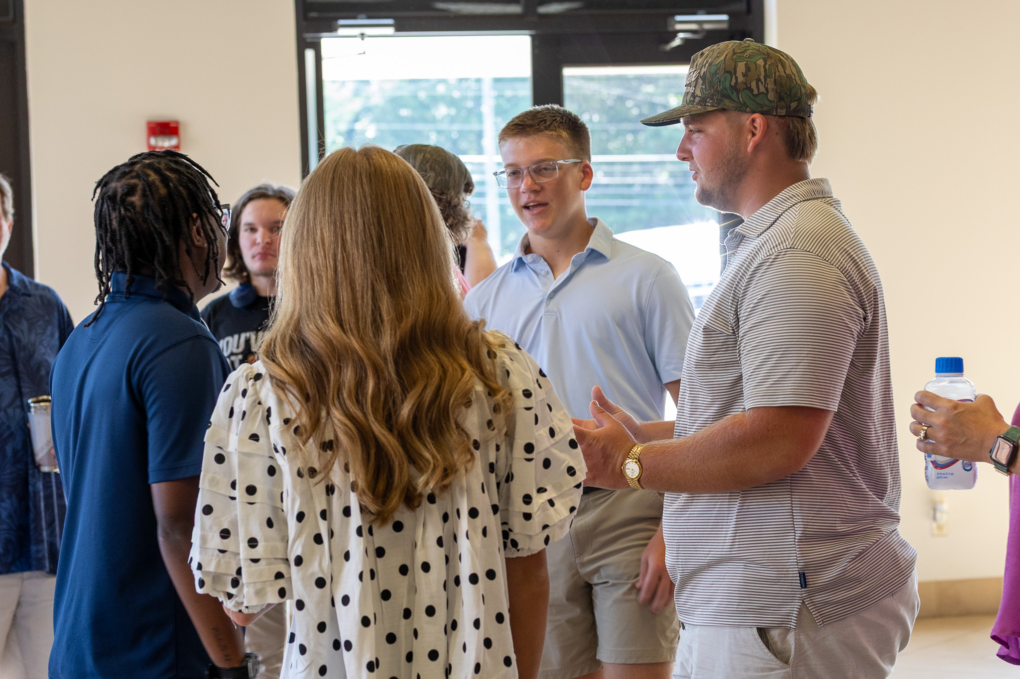 Adults talking together in the church lobby