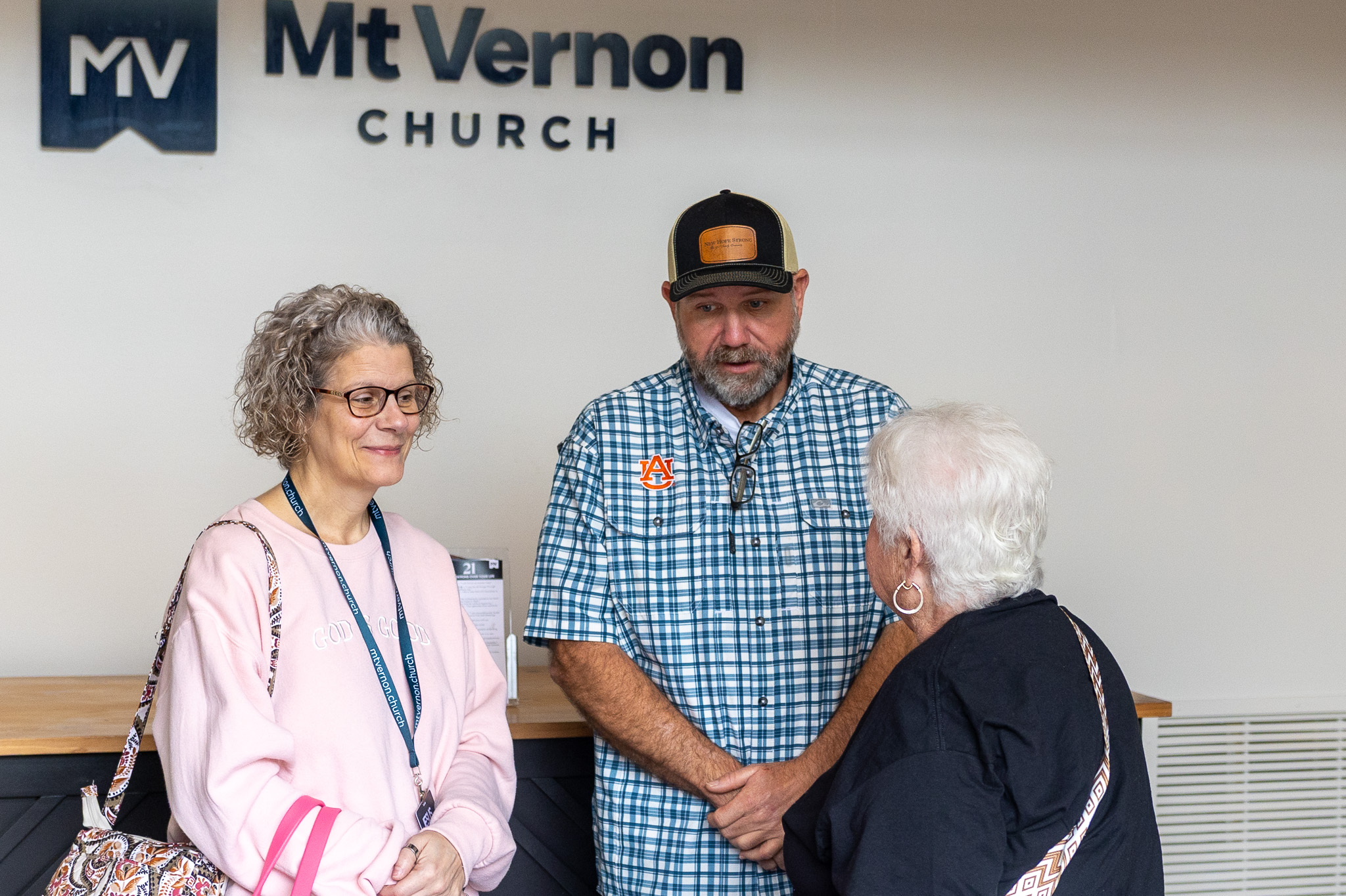 People standing by the Mt Vernon Church sign