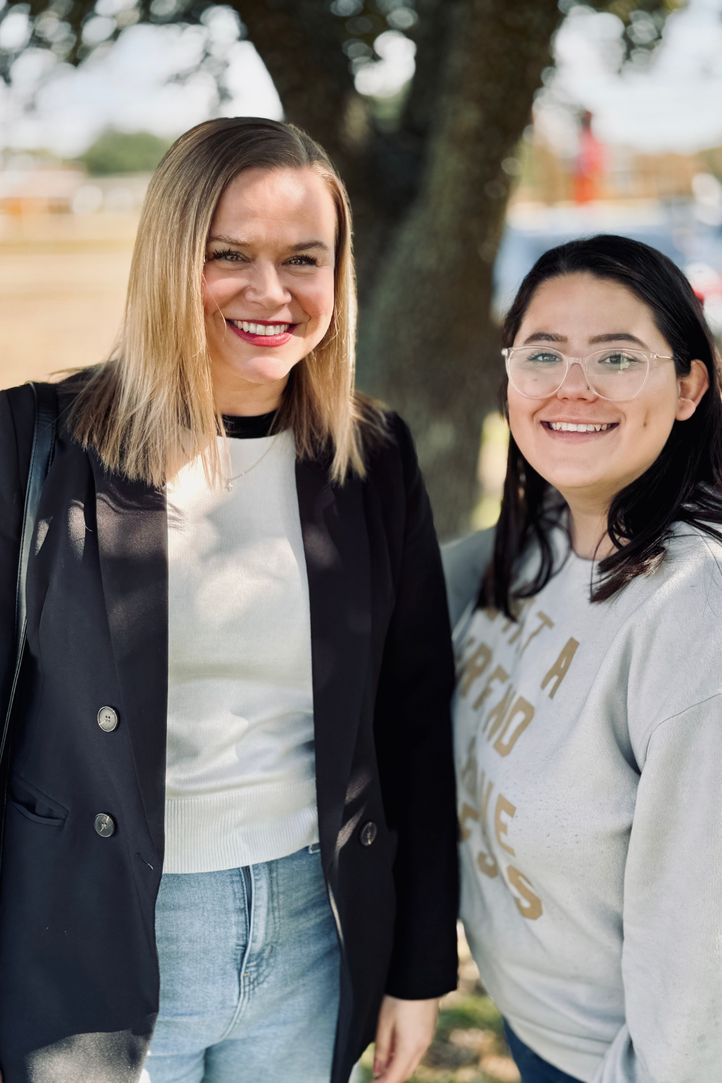 Two young women standing outside after service.