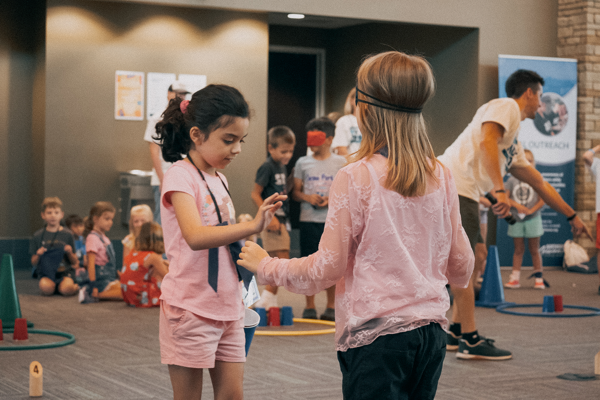 Two young girls participating in games at VBS.