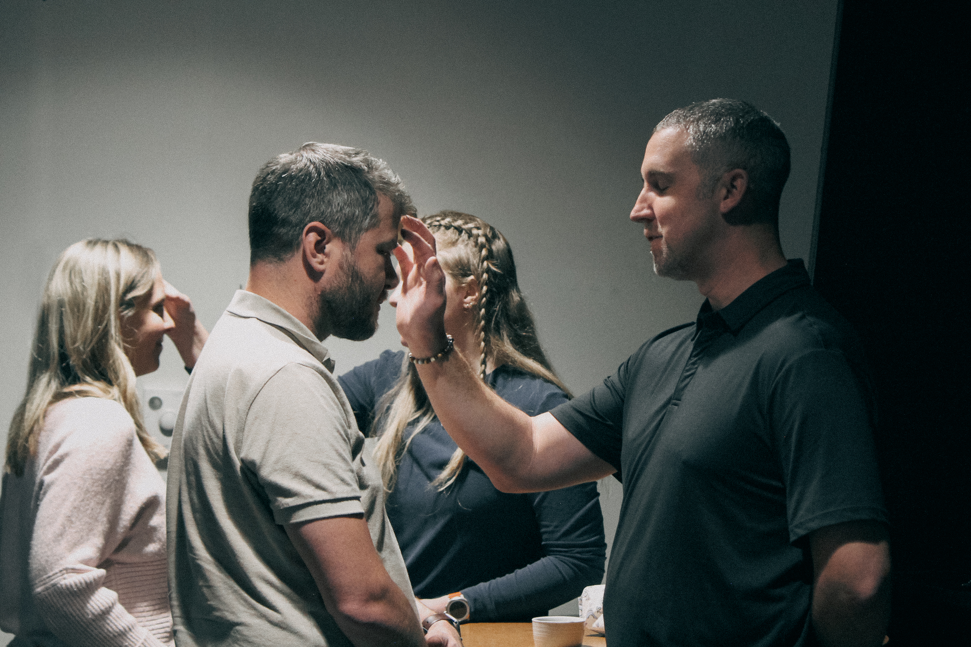 Youth ministers Ben Crain and Rachel Starr spreading ashes on members' heads for Ash Wednesday.