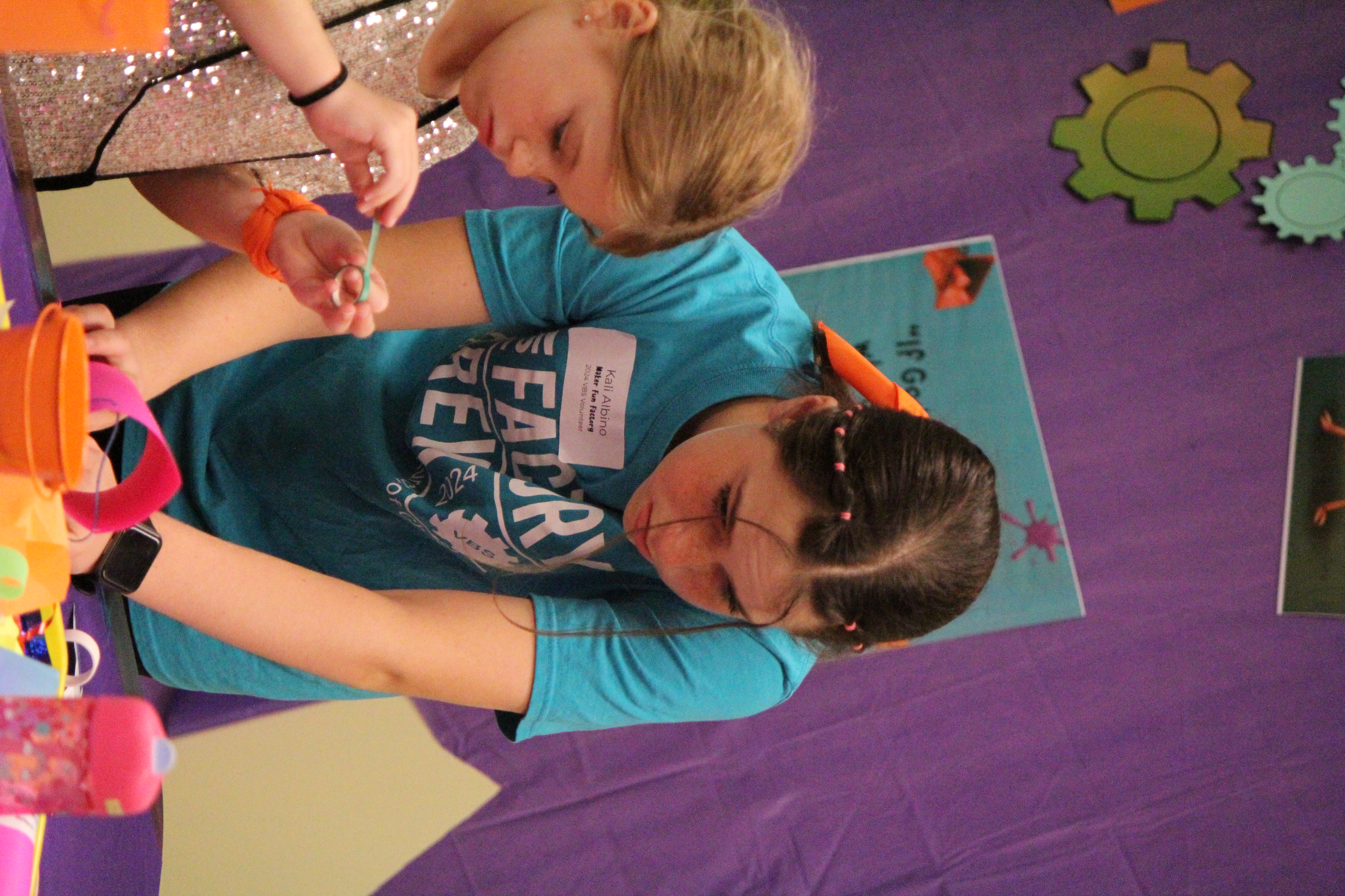 A young father with his toddler are hunting Easter eggs at our Egg-stra Special Egg Hunt.