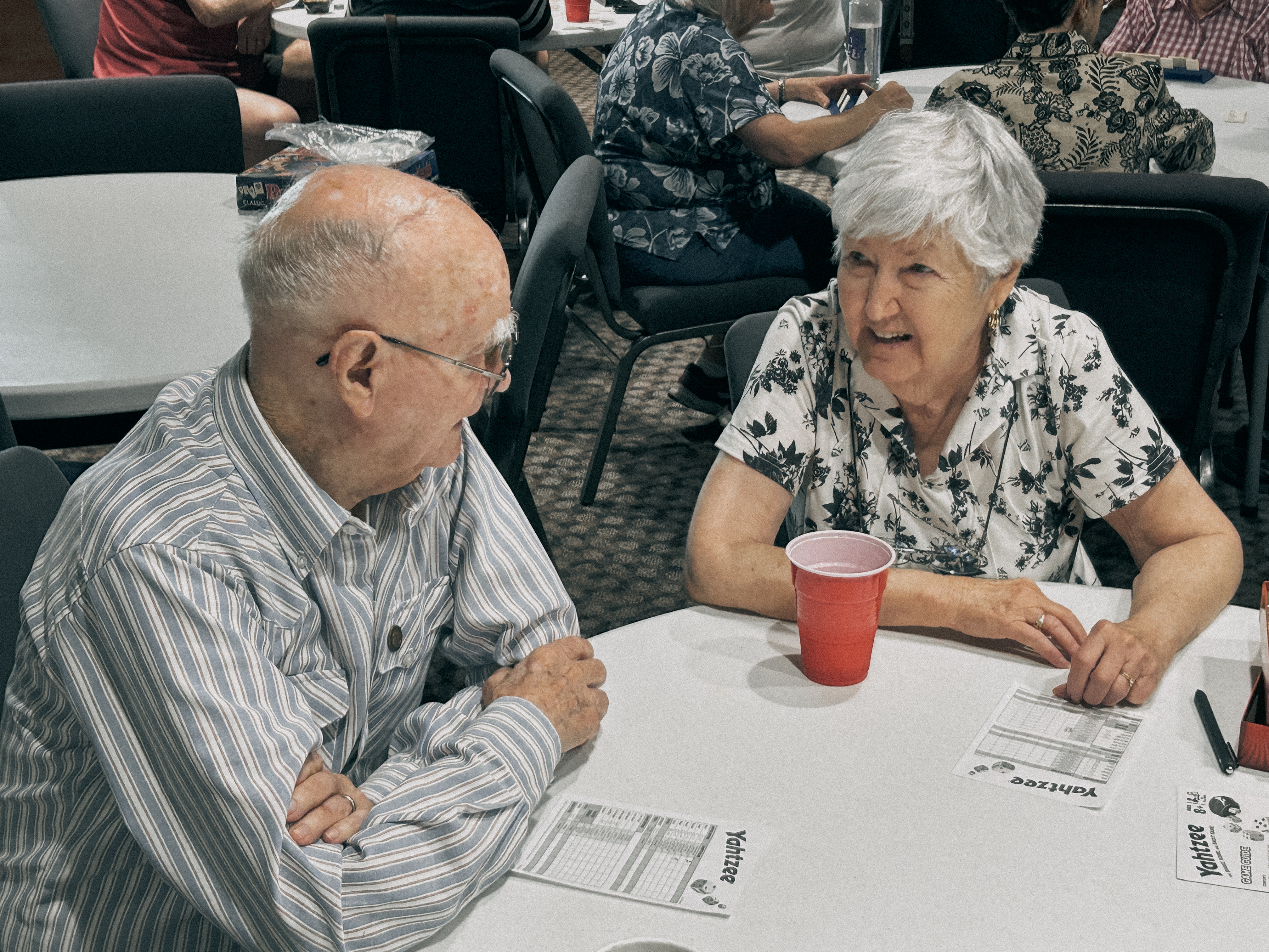 Two of our senior adults playing a game together at our monthly Game Day Lunch