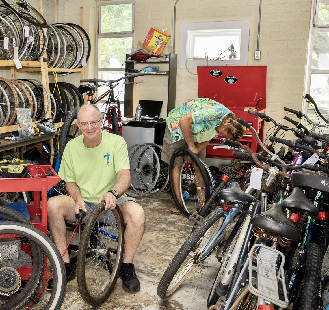 Two men working on bikes