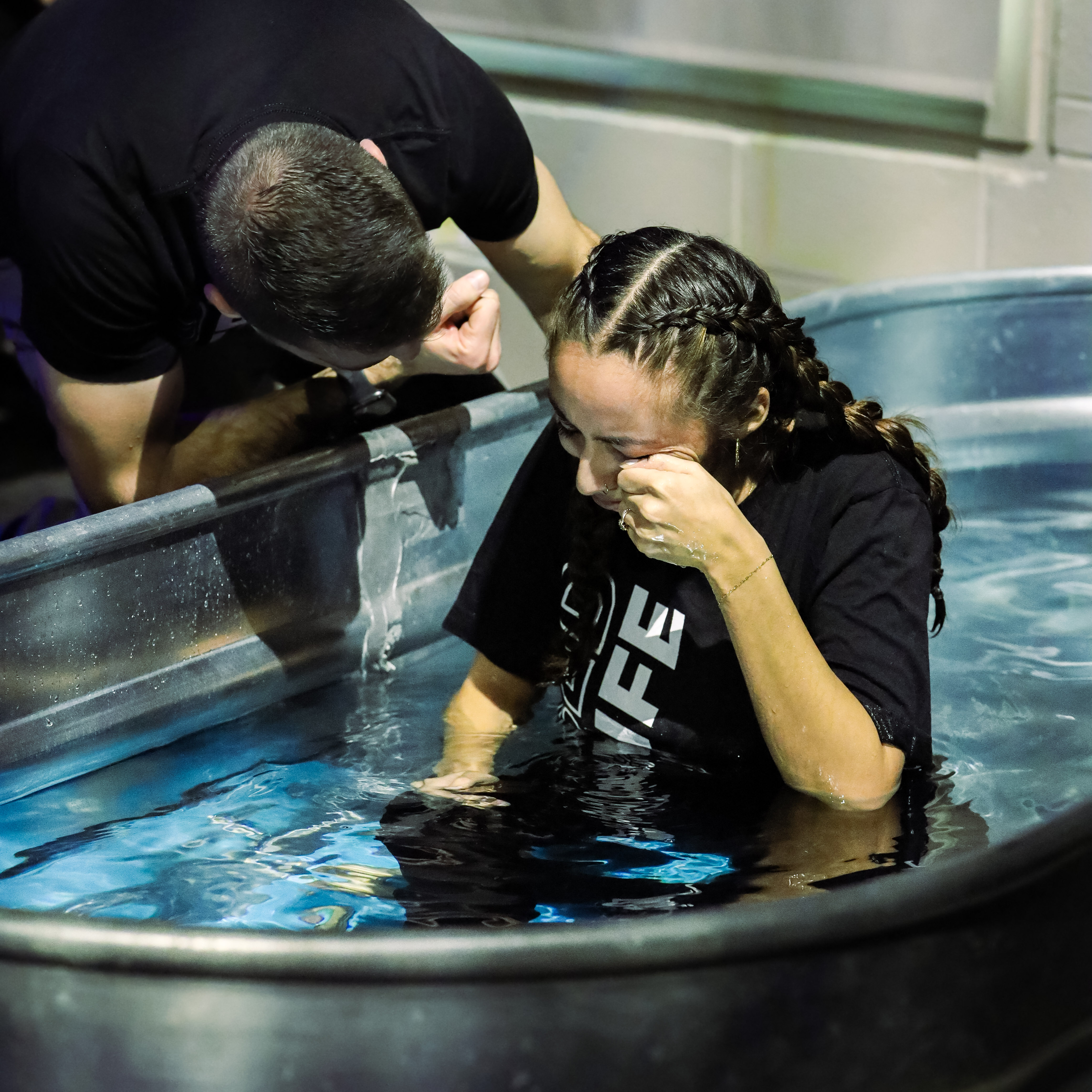 a woman getting water baptized at branch church in jefferson park, chicago, illinois