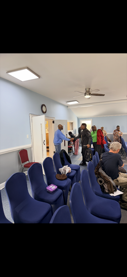 Pastor Craig Hargrow greets Brother Vernon Lightner in the Springhill sanctuary.