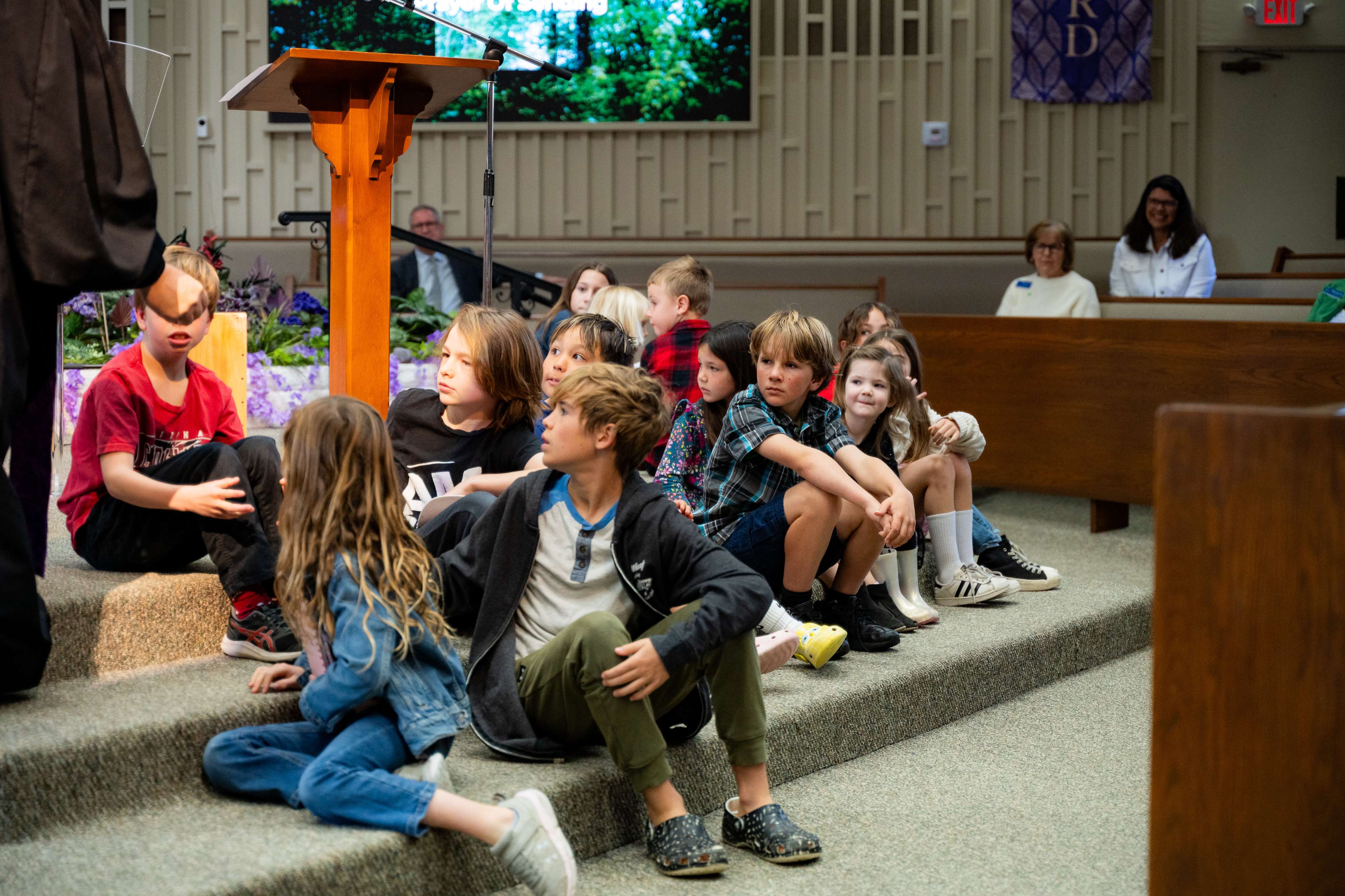 children sitting on the floor during a church service at Oceanside First Presbyterian Church