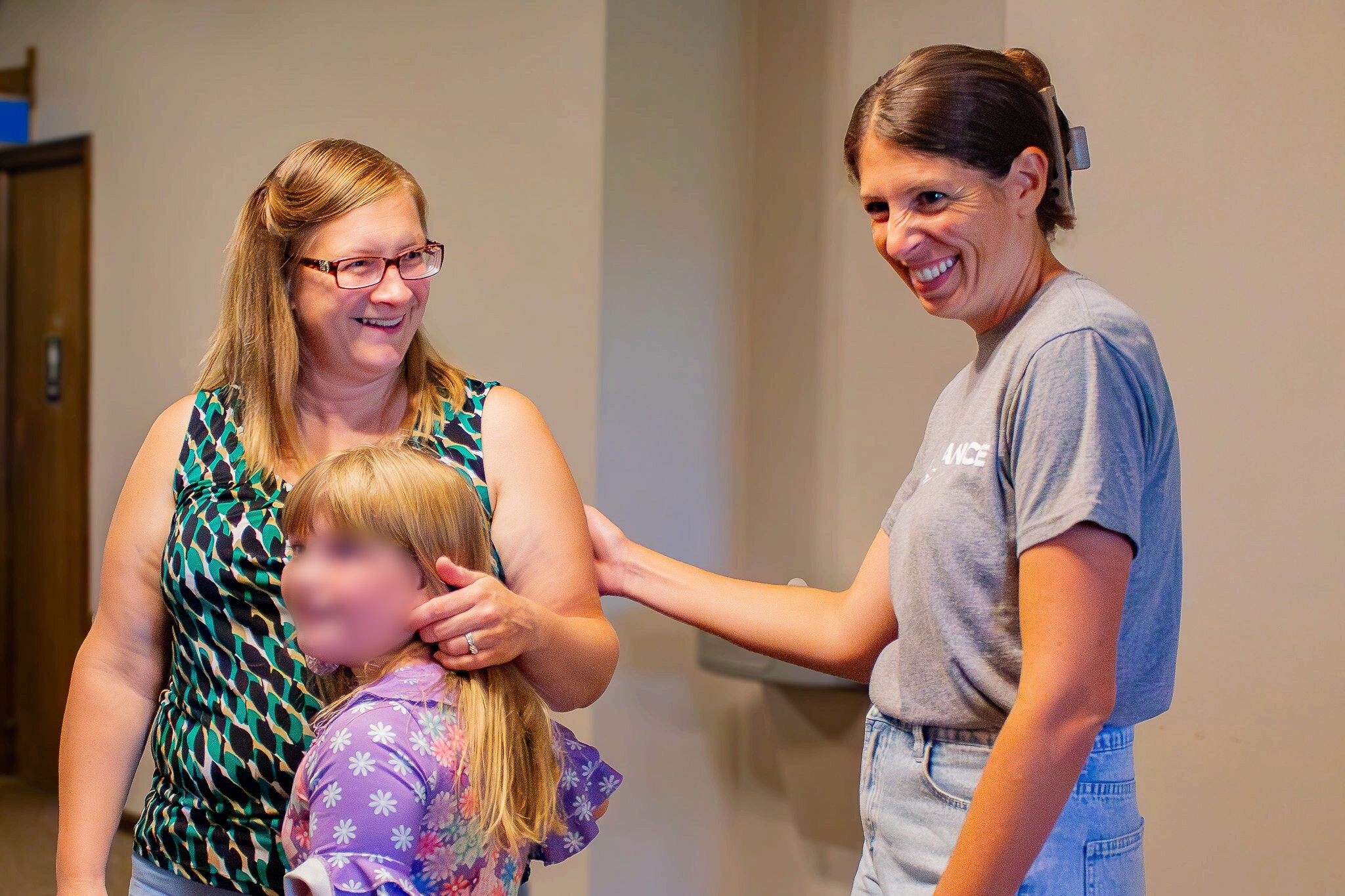 A family welcomed in the Kids Wing at Shelby Alliance Church; the child’s face is blurred for privacy.