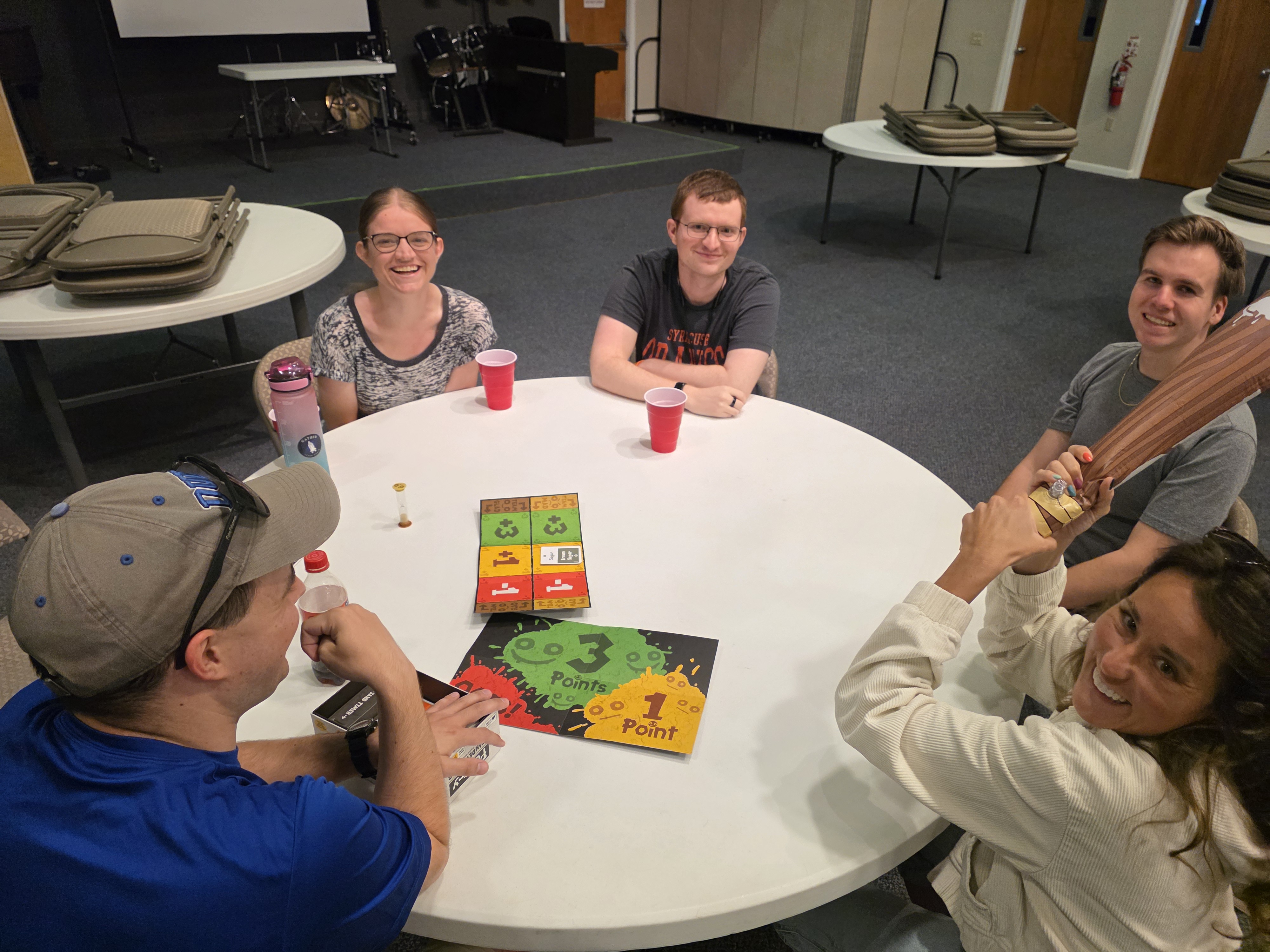 young adults playing a game at a circular table