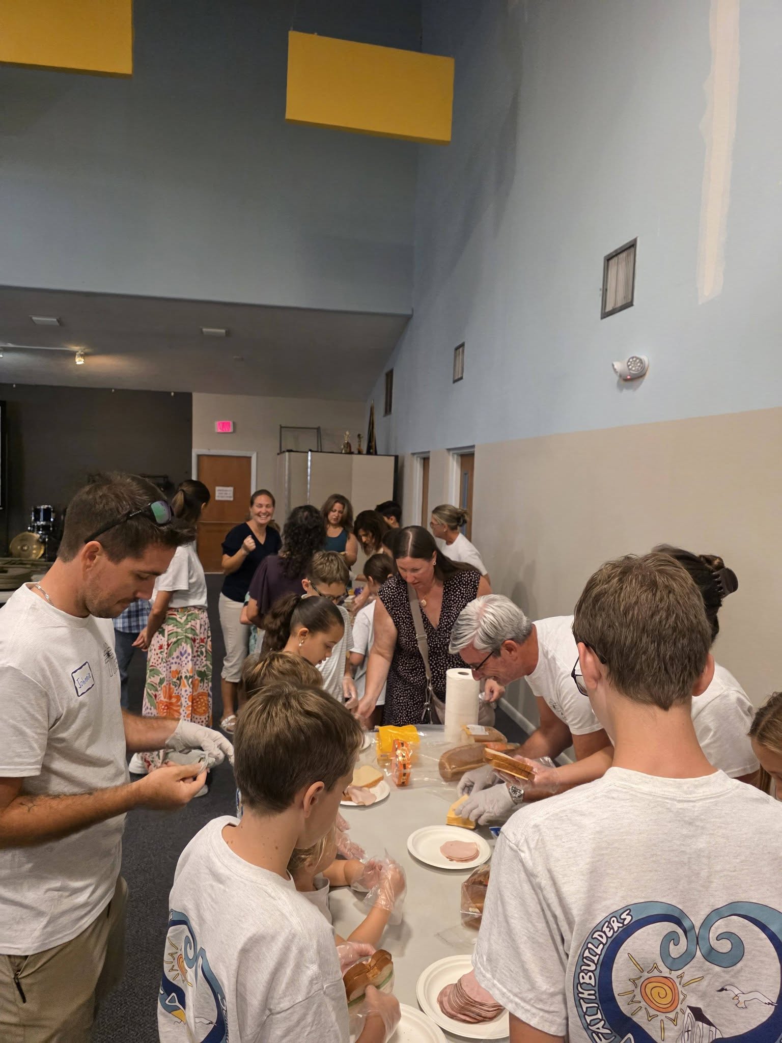 youth group packing sandwiches in an assembly line