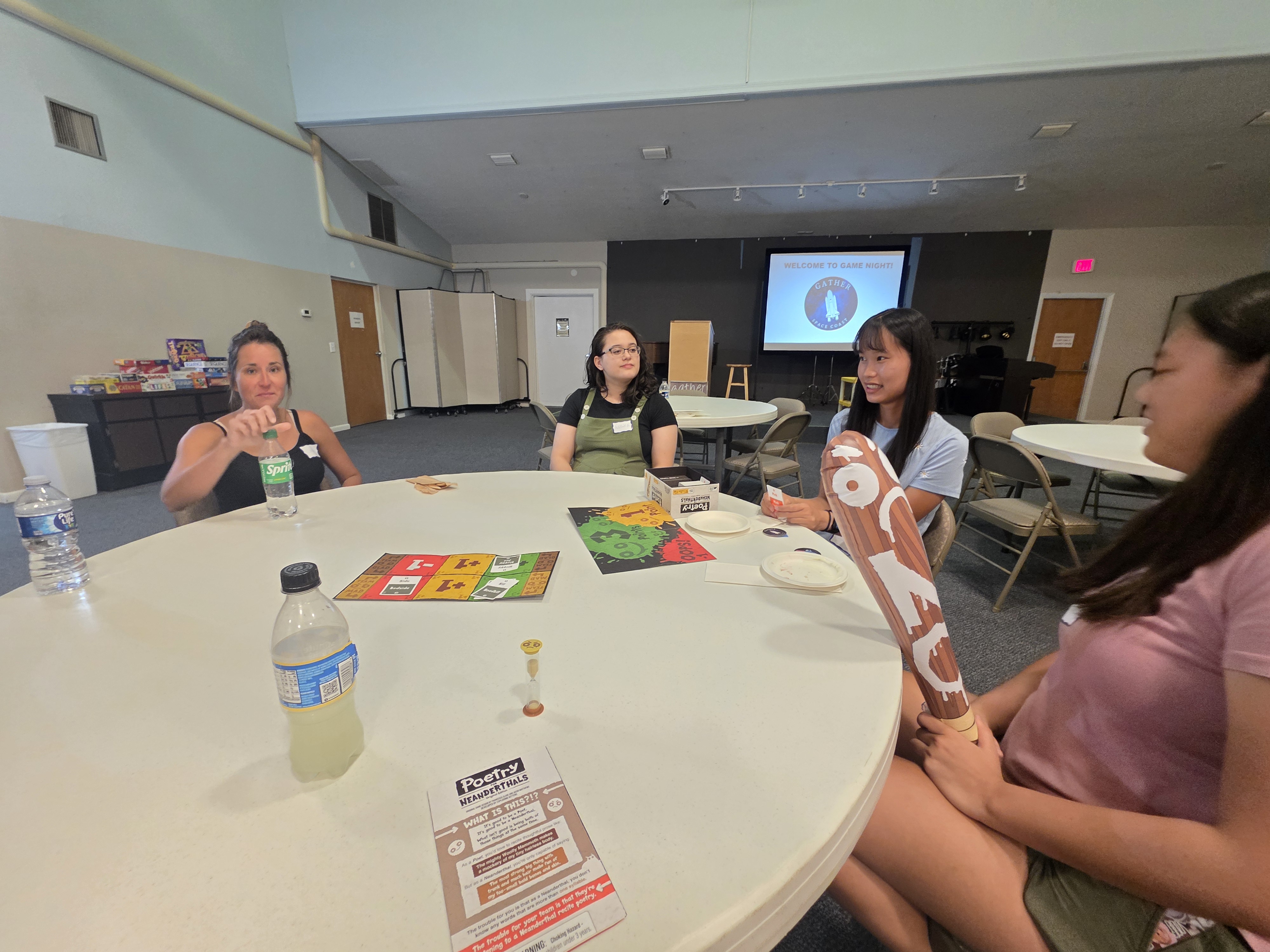 young adults playing a game at a circular table